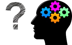 Zdjęcie przedstawia schematyczne przedstawianie ludziej głowy w kolorze czarnym, w środku znajdują się cztery  kolorowe trybiki, a przed głową znak zapytania.