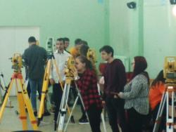 Zdjęcie przedstawia grupę uczniów ze sprzętem geodezyjnym podczas KOnkursu Geodezja z pasją.