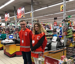 Wolontariusze stoją w sklepie