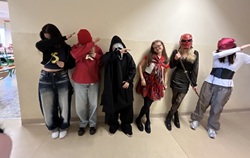 Na zdjęciu widać grupę sześciu uczniów stojących na korytarzu szkolnym. Wszyscy są przebrani w kolorowe i pomysłowe kostiumy, nawiązujące do różnych postaci z bajek lub filmów. Stroje są zróżnicowane – od fantastycznych po nieco mroczne – co nadaje zdjęciu zabawny i kreatywny charakter. Niektórzy uczestnicy wykonują gest „dab”, co podkreśla luźną i radosną atmosferę wydarzenia. Zdjęcie zostało prawdopodobnie zrobione podczas szkolnej zabawy z okazji Dnia Postaci z Bajek.