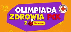 Na zdjęciu znajduje się kolorowa grafika promująca Olimpiadę Zdrowia PCK z Biedronką. Centralną część zajmuje duży, fioletowy kształt z napisem „Olimpiada Zdrowia PCK”, w którym słowo „Zdrowia” wyróżniono żółtym kolorem, a „PCK” czerwonym.